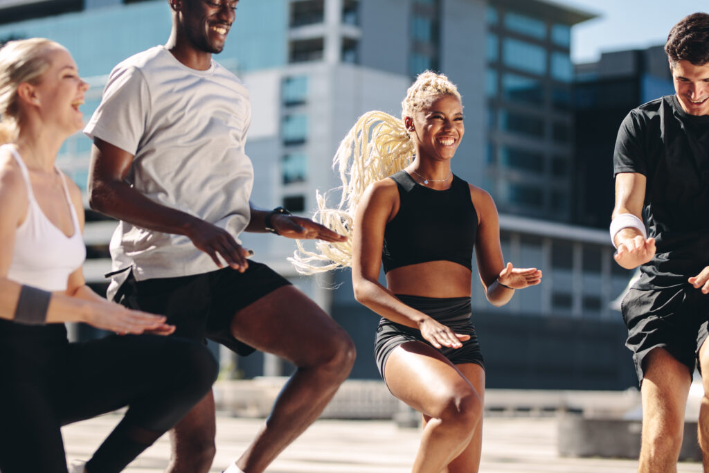 Group,Of,Men,And,Women,Doing,Exercising,Together,In,The